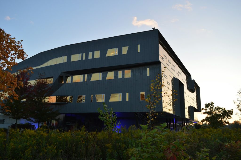 Contemporary commercial building with dark cladding at dusk